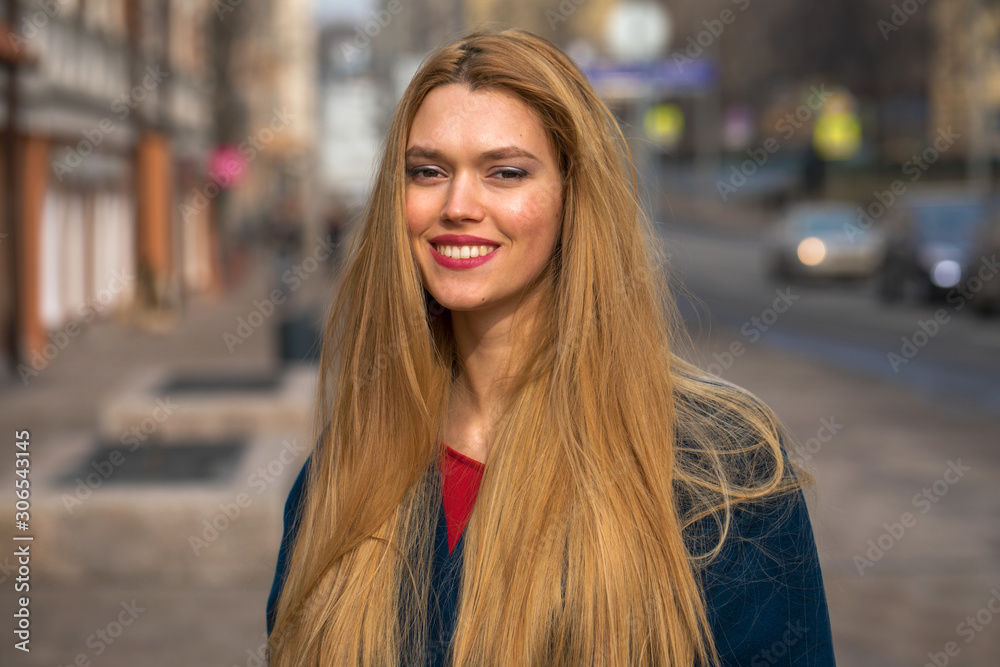 Young beautiful blonde woman in a blue coat Young beautiful blonde woman in a blue coat