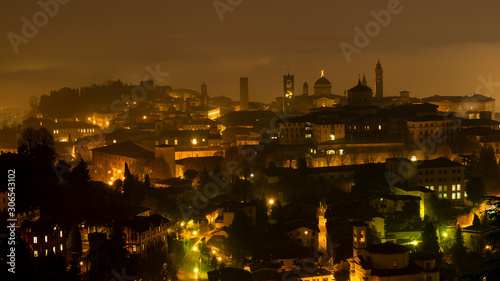 Bergamo, one of the most beautiful city in Italy. Amazing landscape of the fog rises from the plains and covers the old town during the evening. Fabulous context of Italian wonders