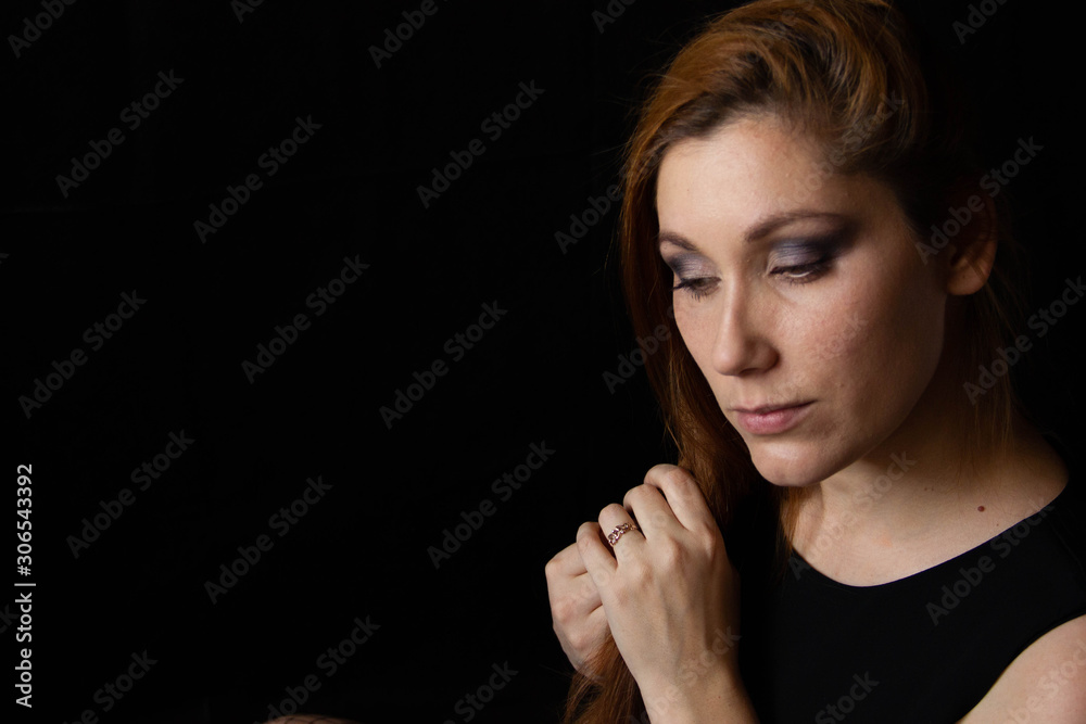 portrait of a young beautiful woman against black background. female face profile portrait of a young beautiful woman against black background. female face profile