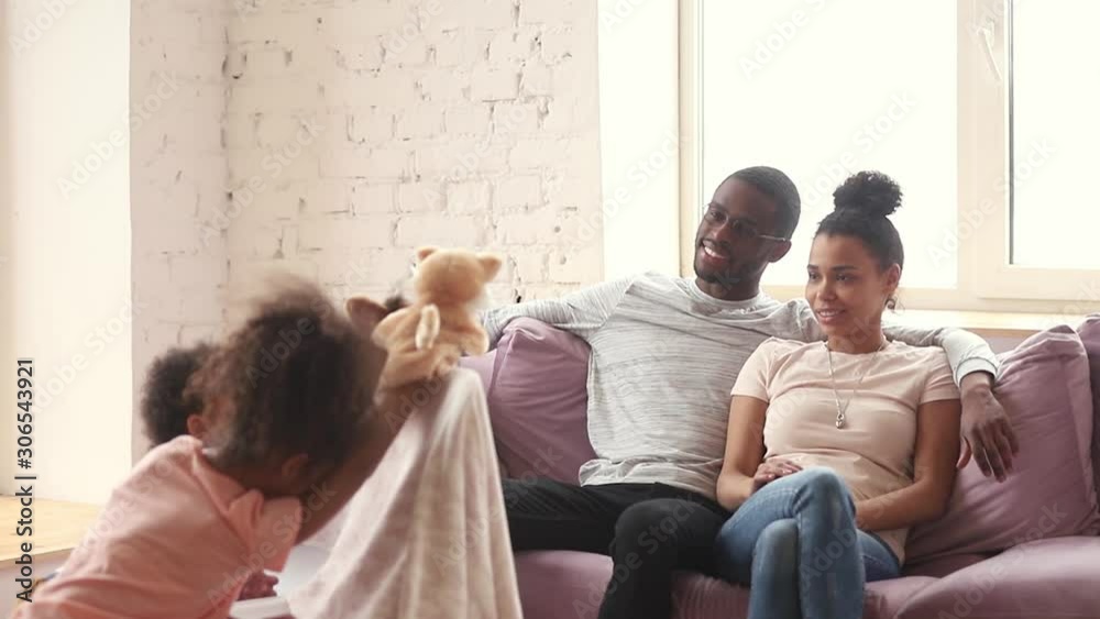 Happy african parents enjoy watching puppet show at home Happy african parents enjoy watching puppet show at home