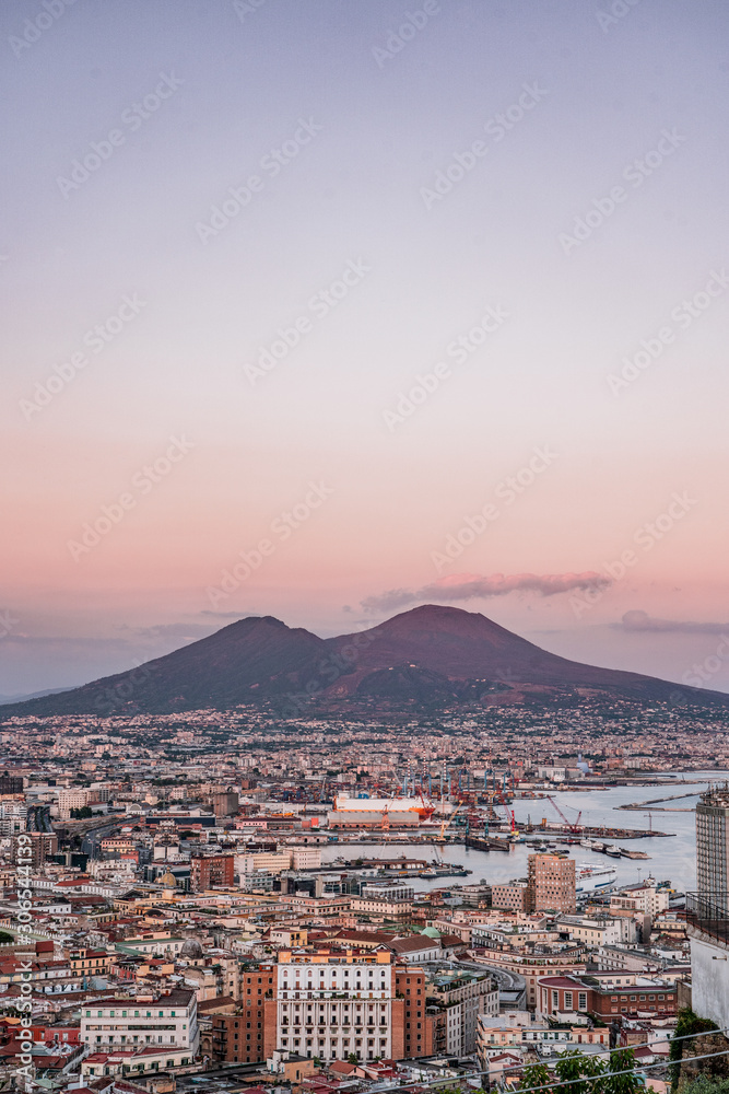 Sunset view of Mont Vesuvius volcano with Naples city in the foreground