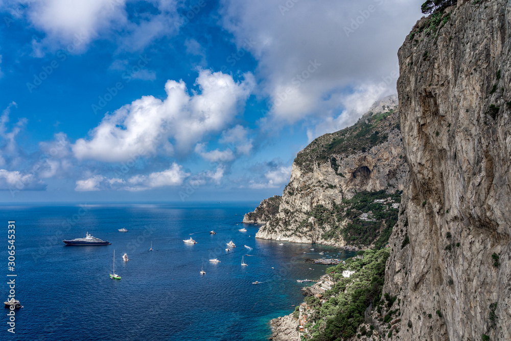 Crag cliff by Tyrrhenian sea in summer with dramatic couds, view from Garden of Augustus, Capri Crag cliff by Tyrrhenian sea in summer with dramatic couds, view from Garden of Augustus, Capri