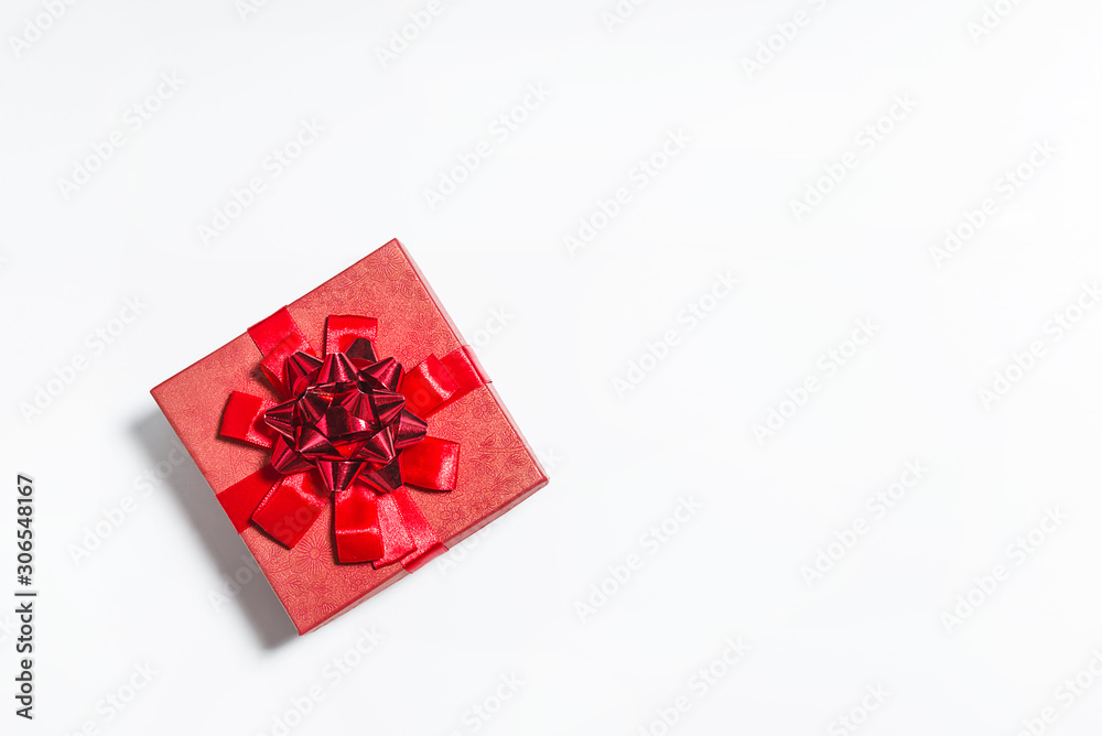 Beautiful red gift box with ribbon on the white background. Copy space, flat lay Beautiful red gift box with ribbon on the white background. Copy space, flat lay