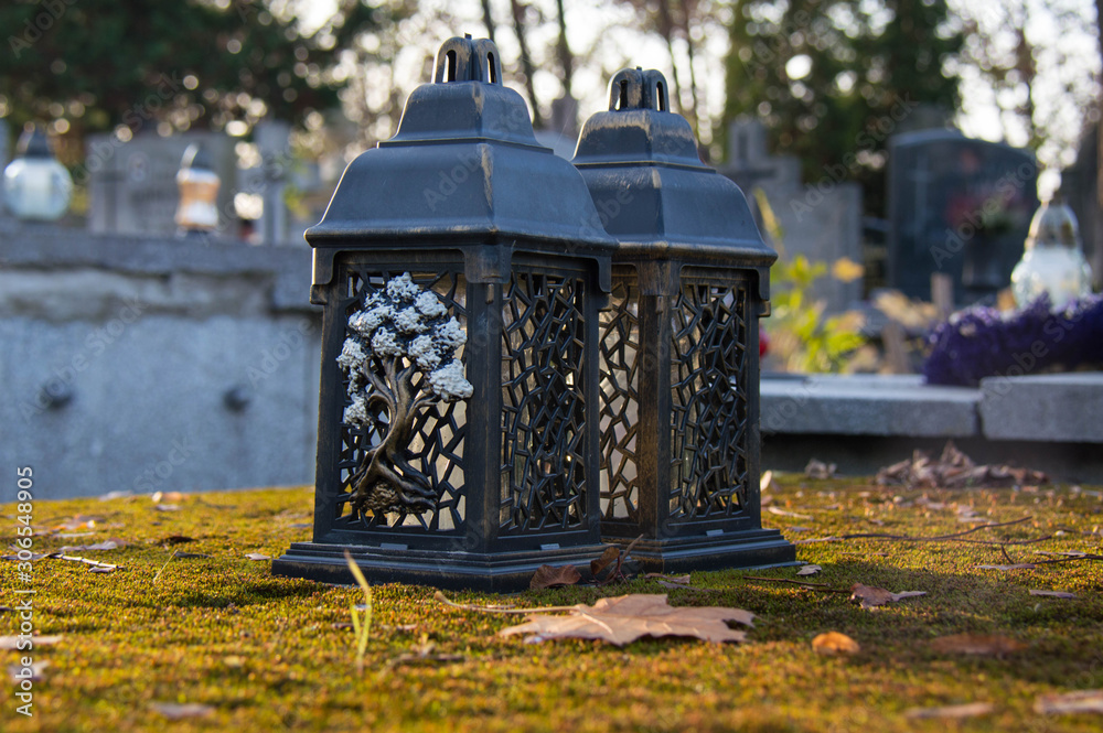 Monument and candles in the cemetery. All Saints Day in Poland. Moss on the tomb. Candles in the cemetery. Monument and candles in the cemetery. All Saints Day in Poland. Moss on the tomb. Candles in the cemetery.
