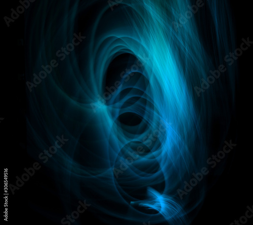 Light painting with multi colored circle effects. Multi color circle and wave effect against a black background. Blue and black.