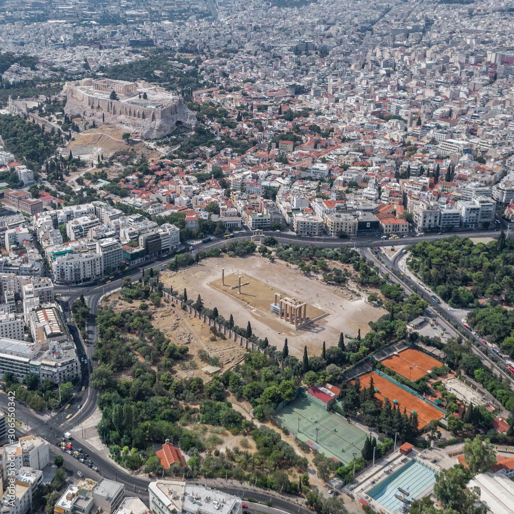 Aerial drone shot of Acropolis of Athens, Olympion Zeus temple, national garden and museum