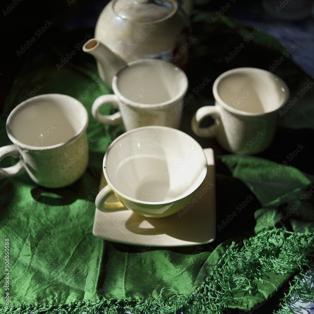 Tea pot and empty cups on a table Tea pot and empty cups on a table