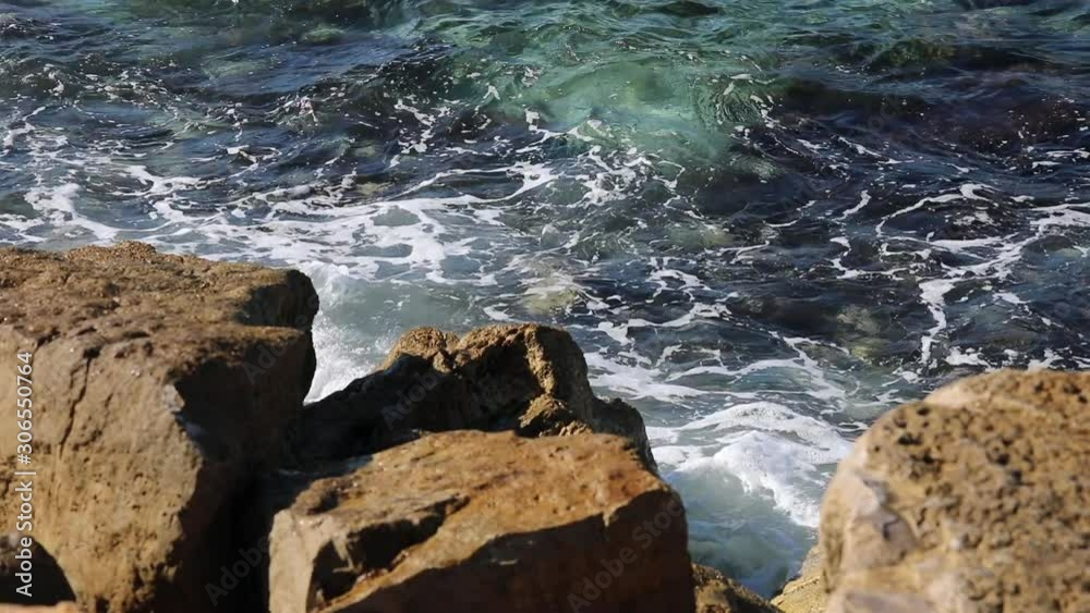 Surf on the stones of the Mediterranean Sea in the Tel Aviv area on a sunny day. Surf on the stones of the Mediterranean Sea in the Tel Aviv area on a sunny day.