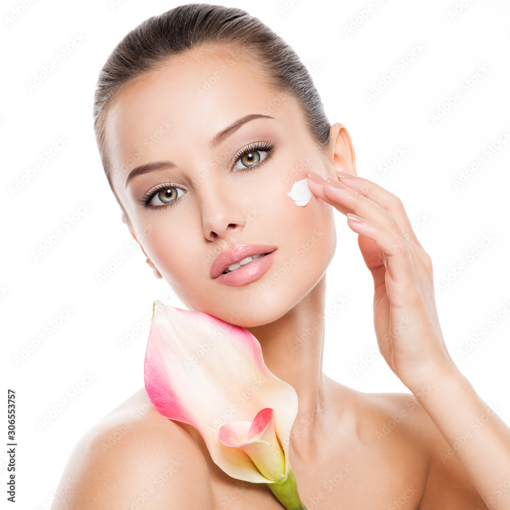 Woman applying cosmetic cream on a face. Woman applying cosmetic cream on a face.