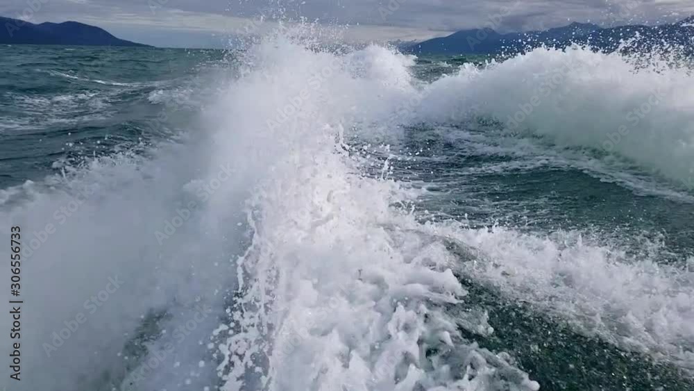 Boat wake captured in slow motion on ocean fjord in Alaska Boat wake captured in slow motion on ocean fjord in Alaska