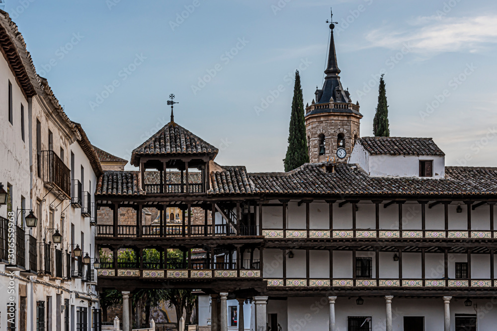 main square of tembleque surrounded by buildings and galleries in height and in the background asuncion church. Toledo Spain.