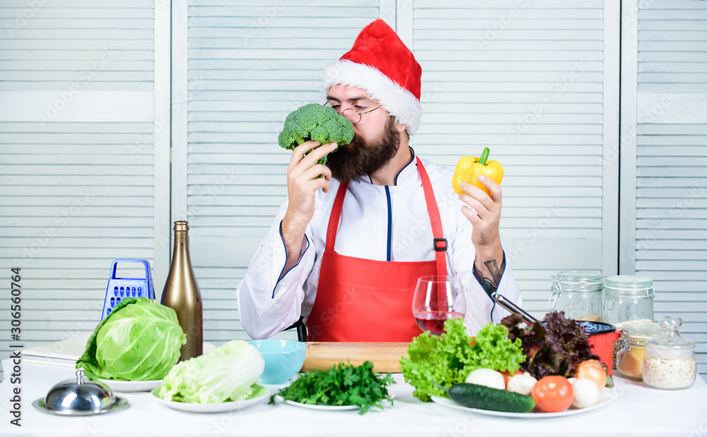 Healthy christmas holiday recipes. How make your christmas dinner healthier. Man bearded chef wear santa claus hat cooking. How to enjoy holiday meals. Enjoy healthy christmas dinner. Christmas diet Healthy christmas holiday recipes. How make your christmas dinner healthier. Man bearded chef wear santa claus hat cooking. How to enjoy holiday meals. Enjoy healthy christmas dinner. Christmas diet