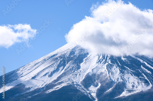 Beautiful Fuji Mountain top view with snow and clouds covered over blue sky winter  Japan