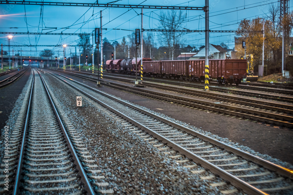 Train tracks fleeing into the distance as seen from the last carriage of the train