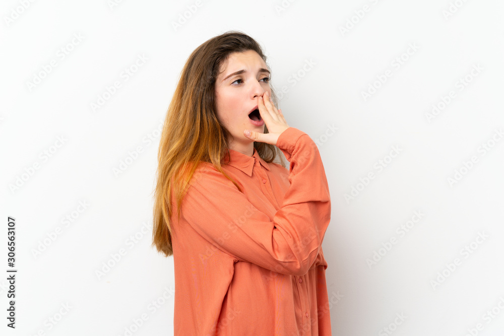 Young brunette girl over isolated white background yawning and covering wide open mouth with hand Young brunette girl over isolated white background yawning and covering wide open mouth with hand