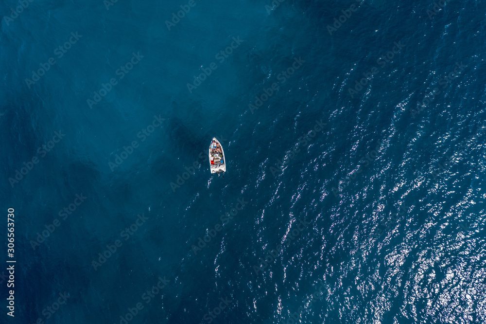 Aerial drone shot view of a boat in Ionian sea near Zakynthos Island 