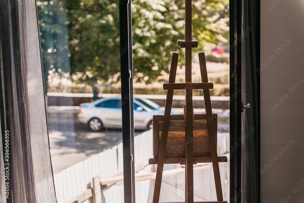 Empty artist's workshop with a painting on an easel