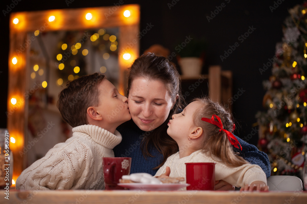 children kiss Mata on the cheek. children's tenderness and love for the mother. children kiss Mata on the cheek. children's tenderness and love for the mother.