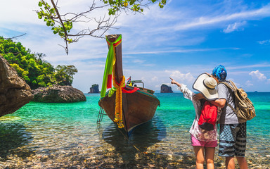 Joyful couple traveler stand on nature clear blue sea water with boat, Travel Krabi Phuket Thailand fun beach, Tourist people on summer holiday vacation trips, Tourism beautiful destination place Asia