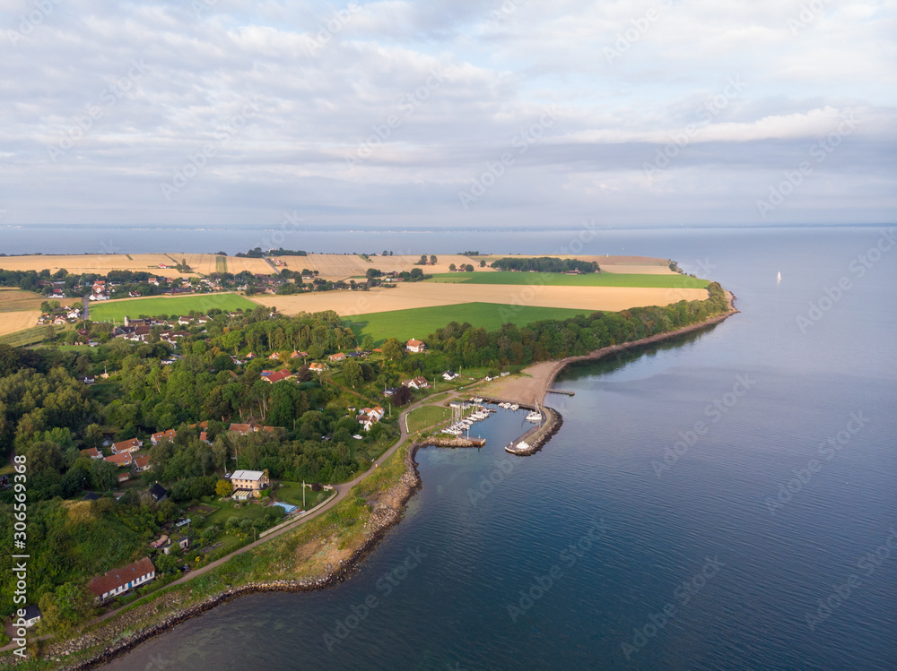 Aerial view of Norreborg harbor on the island of Ven in southern Sweden during a summer sunrise