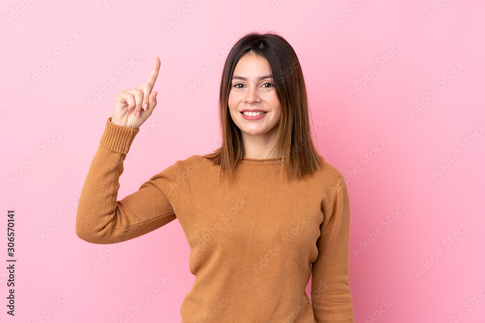 Young woman over isolated pink background intending to realizes the solution while lifting a finger up Young woman over isolated pink background intending to realizes the solution while lifting a finger up