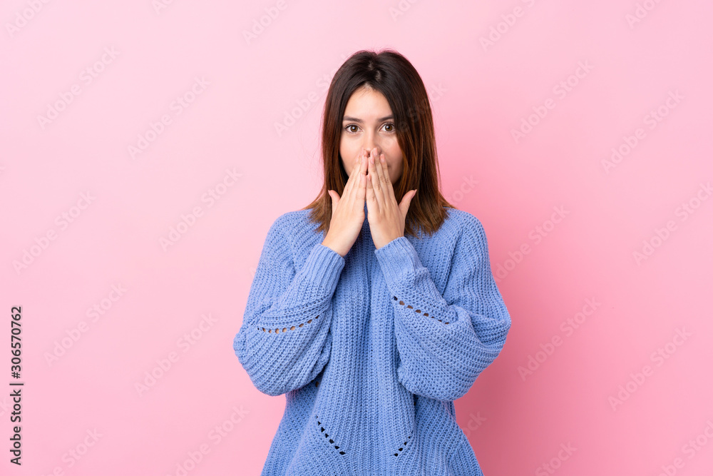 Young woman with blue sweater over isolated pink background with surprise facial expression Young woman with blue sweater over isolated pink background with surprise facial expression