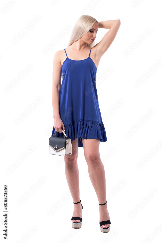 Blonde woman beauty in dress showing armpit soft skin posing with purse. Full body isolated on white background. Blonde woman beauty in dress showing armpit soft skin posing with purse. Full body isolated on white background.