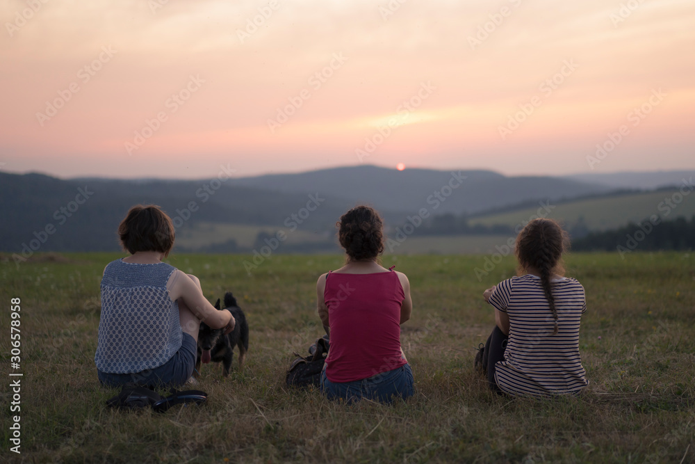 Three women watching sunset in Przemyskie Foothills, Poland