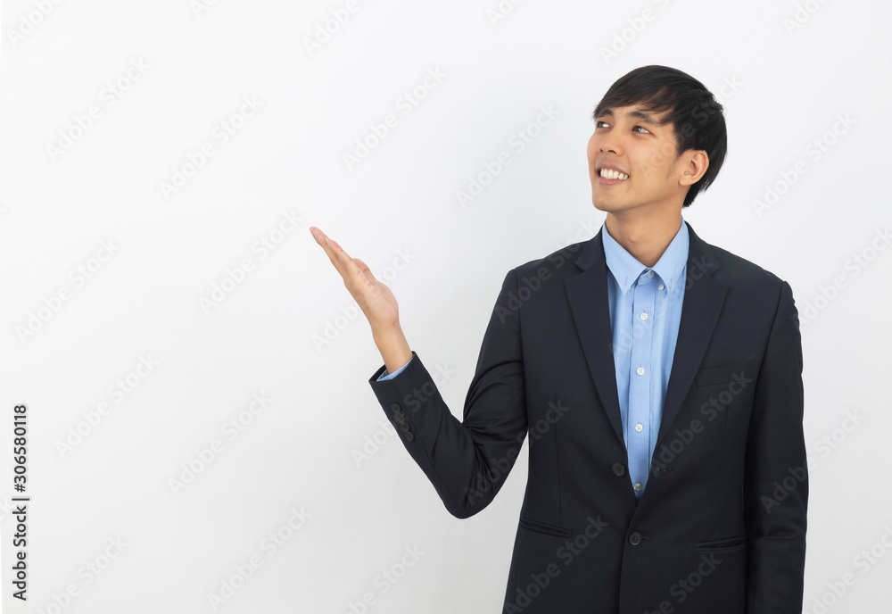 Young asian business man with blue shirt pointing to the side with a hand to present a product or an idea isolated on white background. Young asian business man with blue shirt pointing to the side with a hand to present a product or an idea isolated on white background.