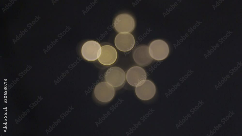 a five-pointed star of white blurry lights goes out and lights up a five-pointed star of white blurry lights goes out and lights up