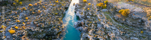 Narrow canyon of Cijevna (Cem), crystal clear mountain river near Podgorica and Tuzi in Montenegro - aerial view. In this ravine the bed is almost brim full with water after heavy rains.