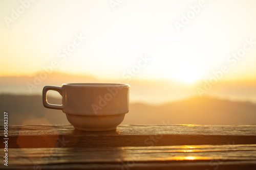 coffee cup and morning light with mountain view,selective focus