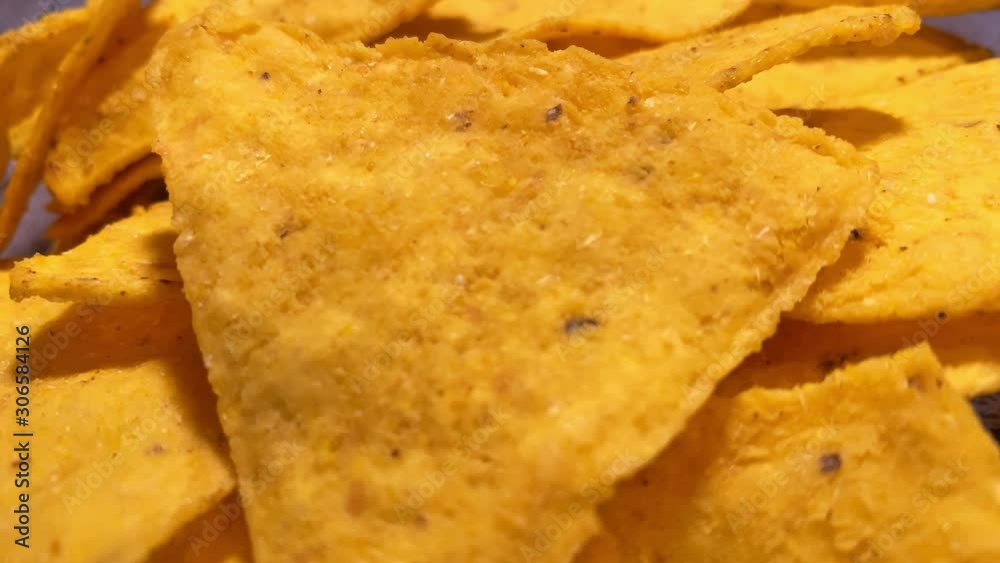 Close up. Triangle nachos corn chips slowly rotating. Unhealthy food 4k stock footage Close up. Triangle nachos corn chips slowly rotating. Unhealthy food 4k stock footage