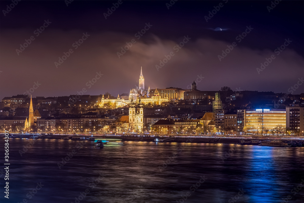 Night citydcape about Budapest with Fishermens bastion and Matthias church. Included Danube river and Batthany square