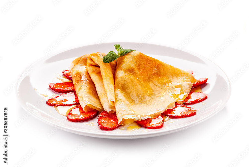 Tasty crepes with strawberries on white background Tasty crepes with strawberries on white background