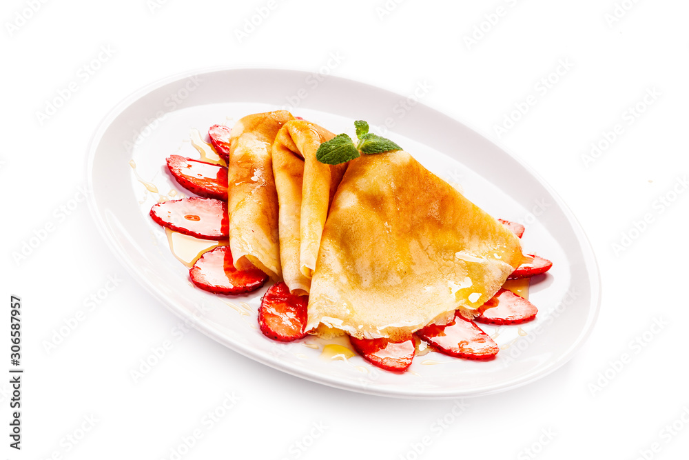 Tasty crepes with strawberries on white background Tasty crepes with strawberries on white background