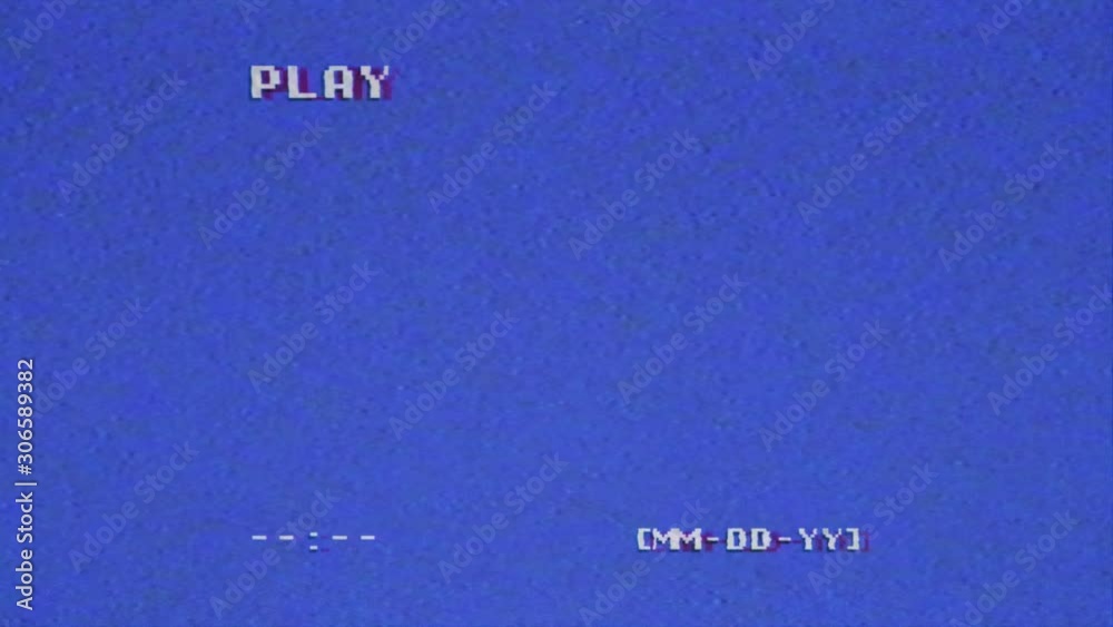 An old VHS tape capture, analog signal with an intentional distortion effect. Blue background, small text with a missing date, a play message, bad artifacts. Long-lasting clip.