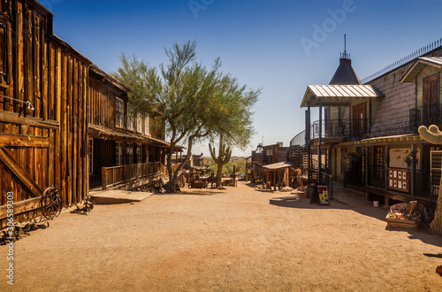 Old Western Goldfield Ghost Town square with huge cactus and saloon, photo taken during the sunny day with clear blue sky