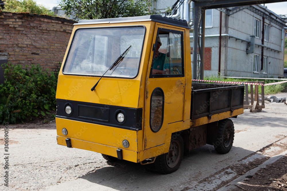 The electric car moves through the territory of the plywood factory