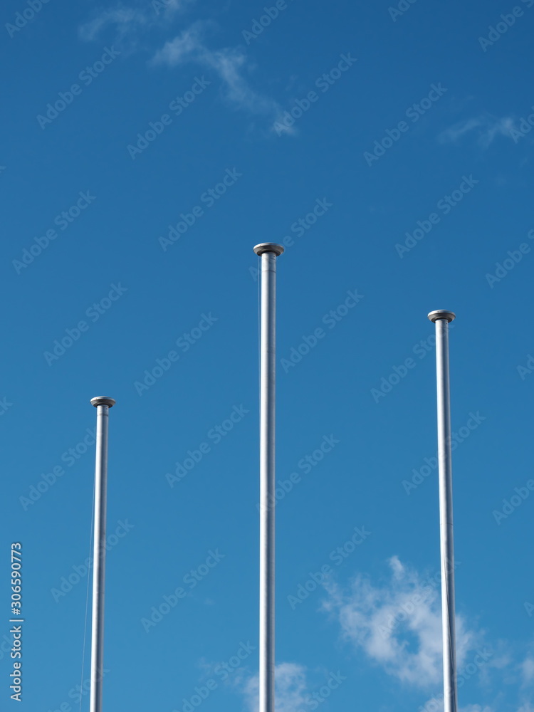 Tokyo,Japan-November 29, 2019: Three flagpoles under blue sky in Tokyo