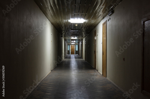 Long dark corridor in an old industrial building © vadim_fl