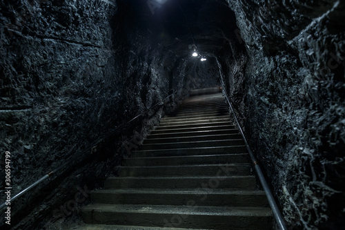 Empty lonely abandoned stairs in a rocky underground, stairway to heaven or hell