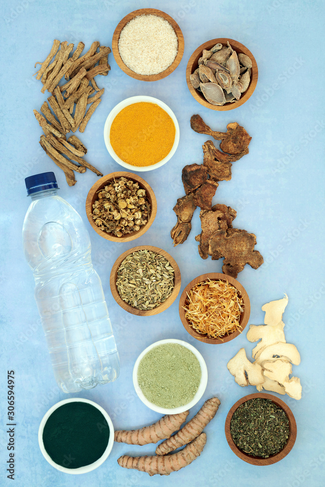 Herbs & spice used in chinese herbal medicine to ease irritable bowel syndrome with dietary supplement powders & spring water. Natural health care concept. Flat lay, top view. Herbs & spice used in chinese herbal medicine to ease irritable bowel syndrome with dietary supplement powders & spring water. Natural health care concept. Flat lay, top view.