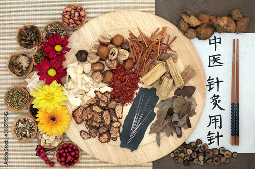 Chinese herb selection & acupuncture needles with calligraphy script. Translation reads as acupuncture needles used in traditional chinese medicine. Flat lay, top view. Natural health care concept. photo