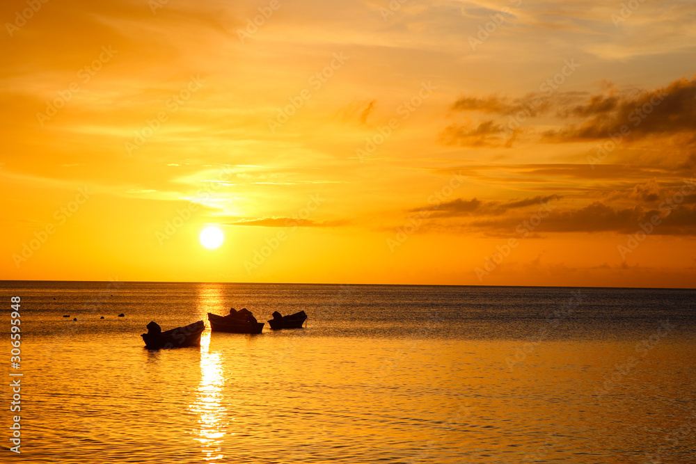 sunset on sea with fisherman boats