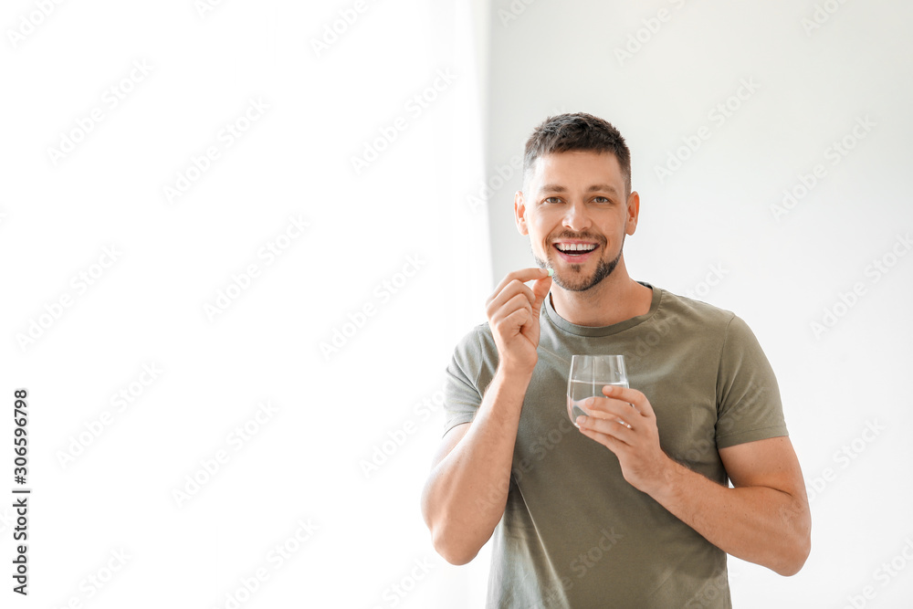 Man taking medicine at home Man taking medicine at home