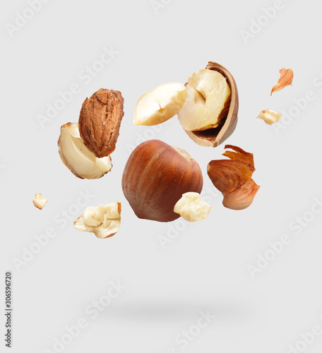 Falling hazelnuts on light background photo