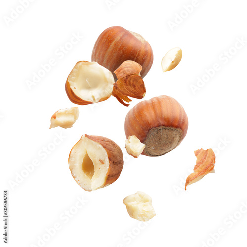 Falling hazelnuts on white background photo