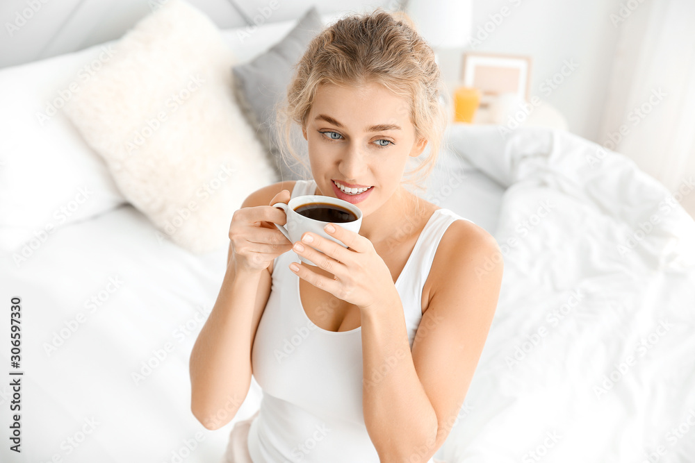 Morning of beautiful young woman drinking coffee in bedroom Morning of beautiful young woman drinking coffee in bedroom