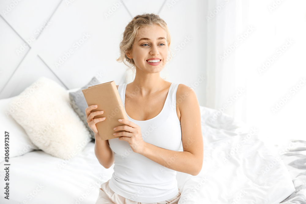 Morning of beautiful young woman with book in bedroom Morning of beautiful young woman with book in bedroom